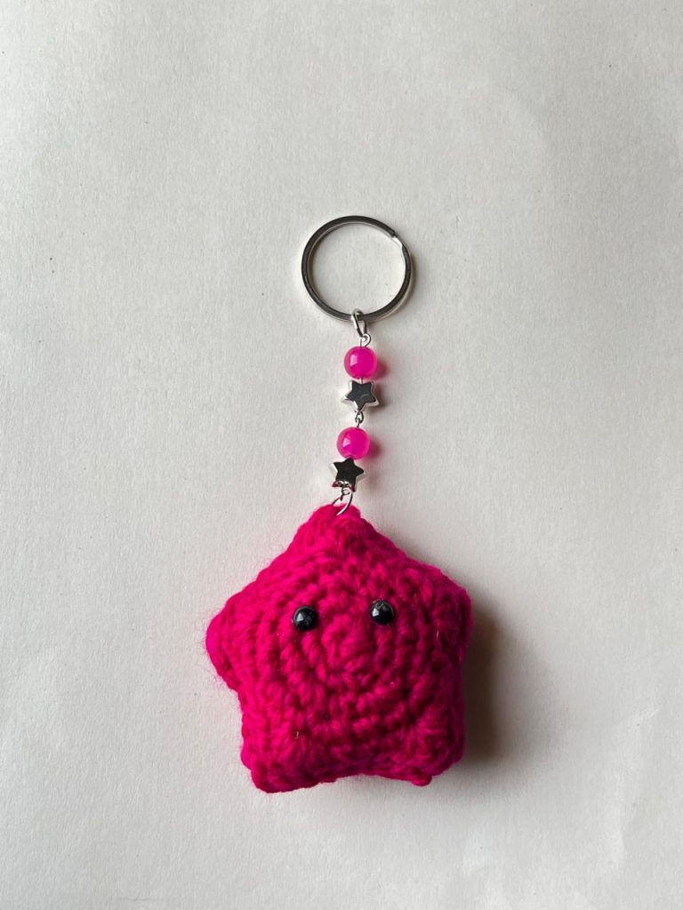 Handmade crochet pink star keychain with decorative beads and metal ring by Veloura