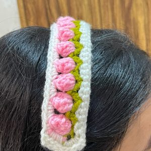 Pink handmade crochet floral headband with green leaf detailing