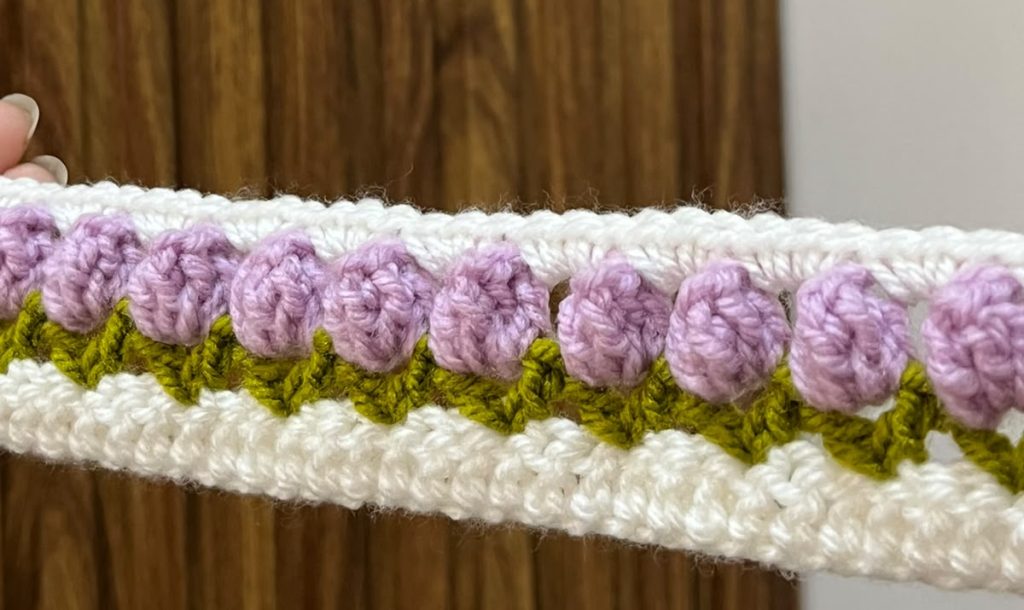 Handmade lavender crochet floral headband with green leaves by Veloura